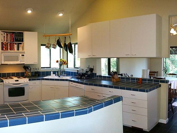 Kitchen includes dual-fuel Jenn-Aire, cabinets w/pullouts, & breakfast area 