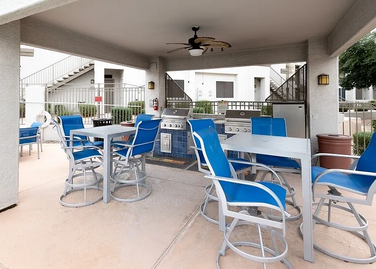 Covered Patio with mini fridge and grill at the pool