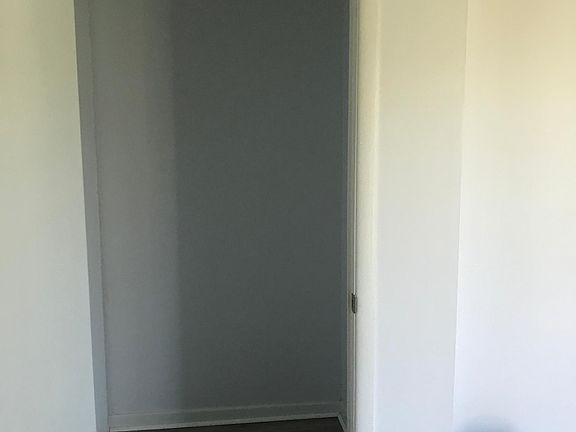 Large walk in closet. Add your own shelving units.