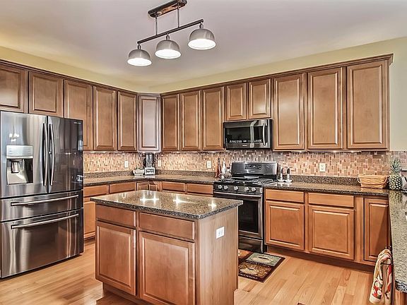 Spacious Kitchen with New Black Stainless Steel Appliances