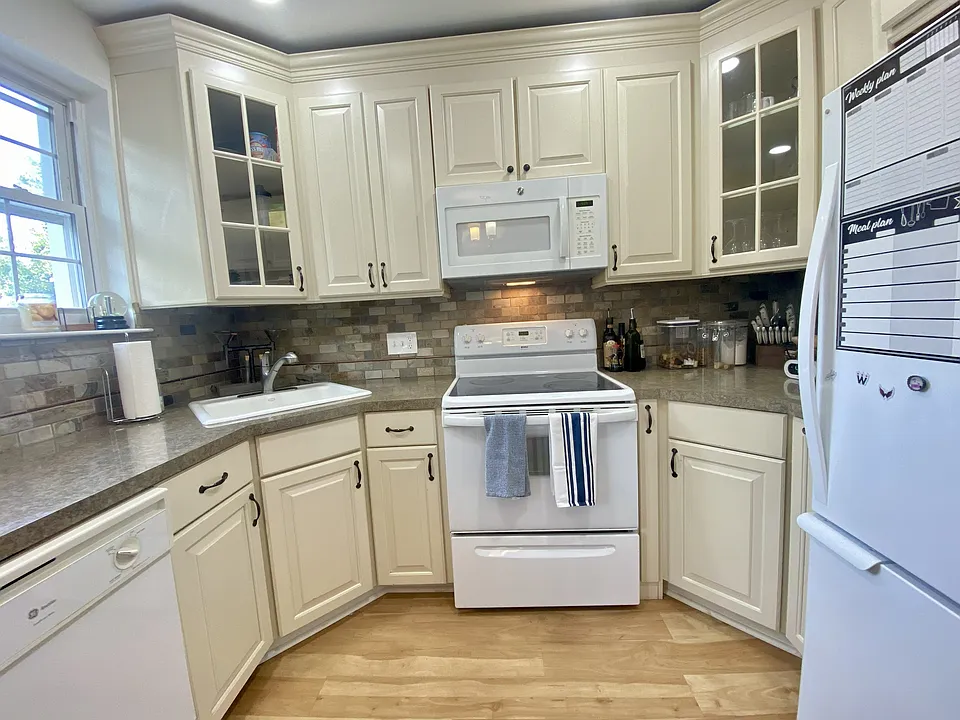 Lots of cabinets, spice rack to the side of the stove, pull out organizer for pans on the left side of the stove. There is also under cabinet lighting (Not pictured)