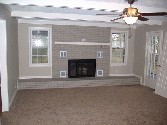 Den with working gas fireplace