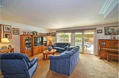 Spacious living area leading to backyard with pool