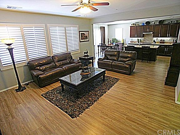 Spacious Family Room opens to the Kitchen giving you that great room feel complete with Plantation Shutters and Upgraded flooring throughout!