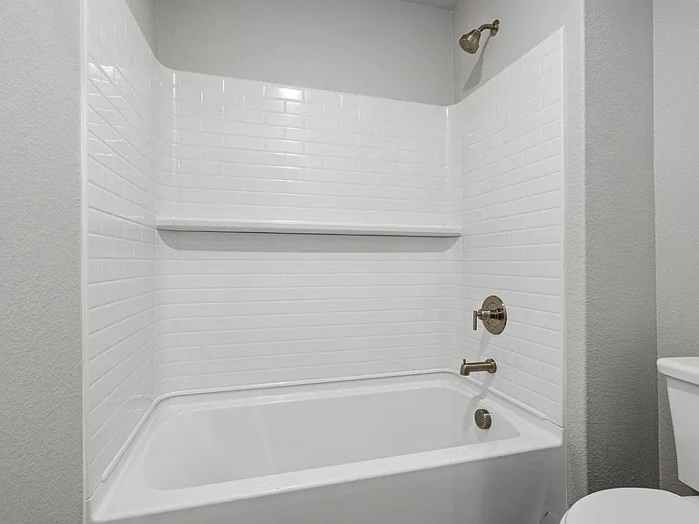 The secondary bathroom has a shower-tub combo.