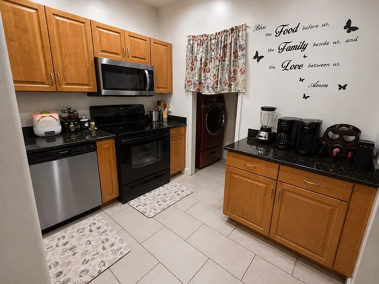 Kitchen with new porcelain tile. New microwave and dishwasher