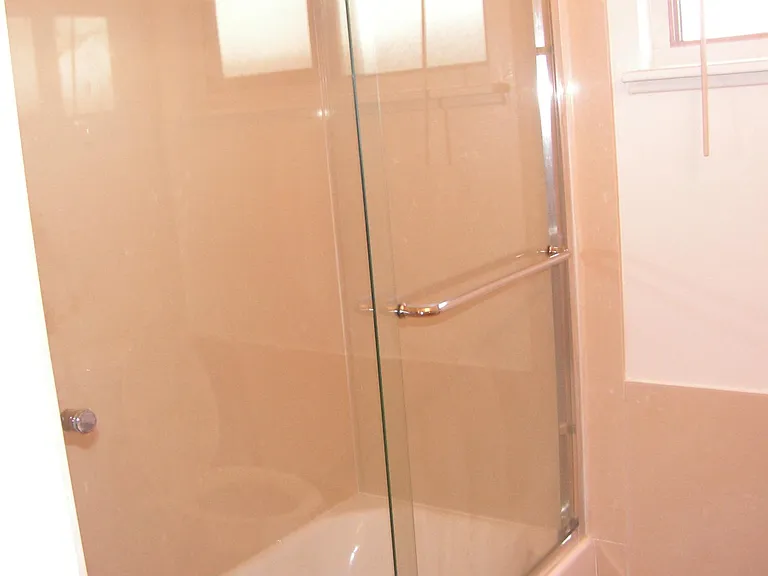 The bathroom has a shower and bathtub.