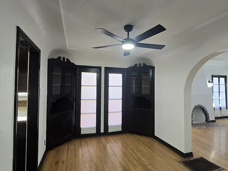 BUILT IN CHINA CABINETS WITH FRENCH STYLE DOORS THAT OPEN TO A SIDE PATIO
