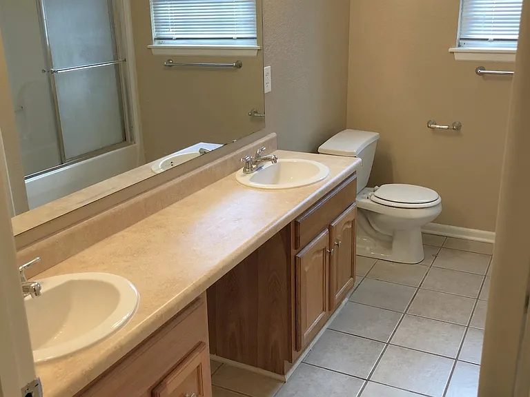 Full Bath with dual sinks, linen closet, tile flooring