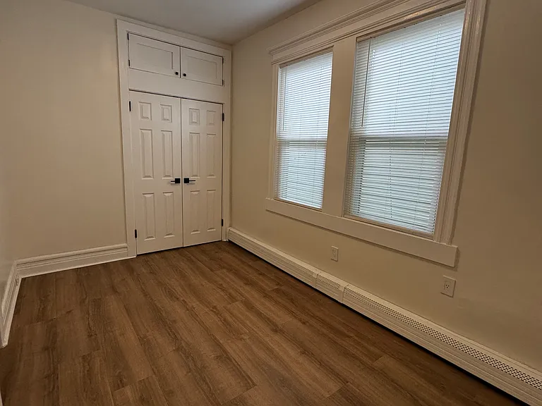 Bedroom 1 (Actual Room): Bright and inviting bedroom with generous natural light, a spacious closet, and overhead storage for added organization. Perfect for a comfortable bedroom or guest room