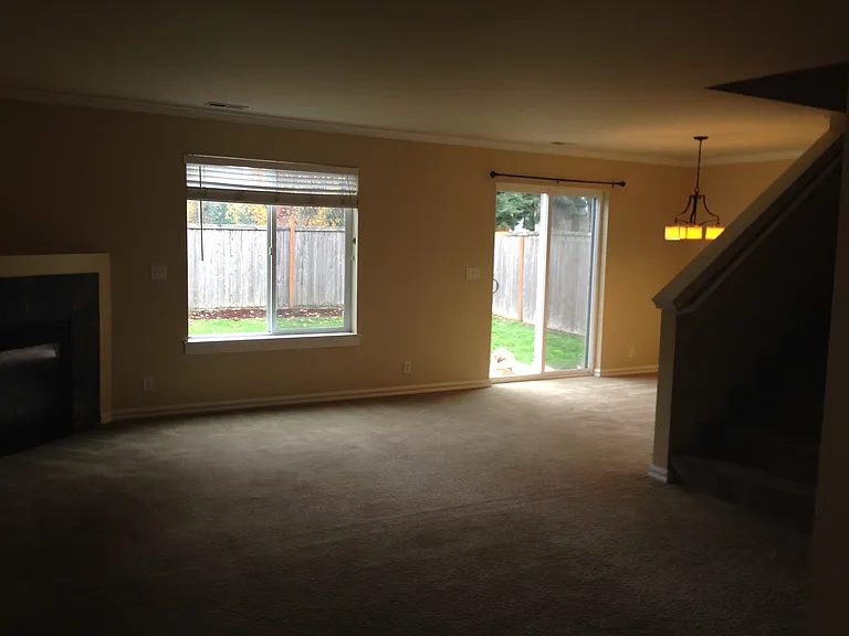 Living and dining area with access to fenced back yard