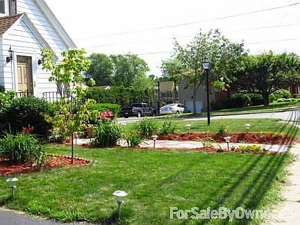 More of Front Yard : Enjoy professionally-landscaped three-season perennial flowerbeds
