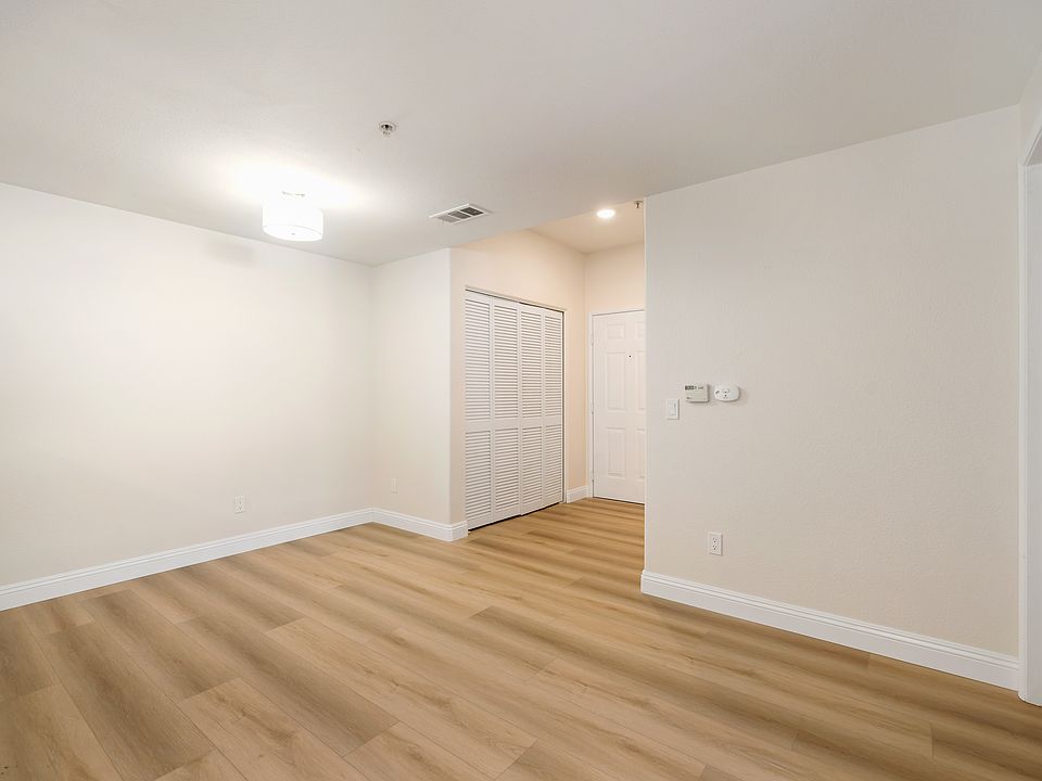 View of dining area, entry and laundry closet