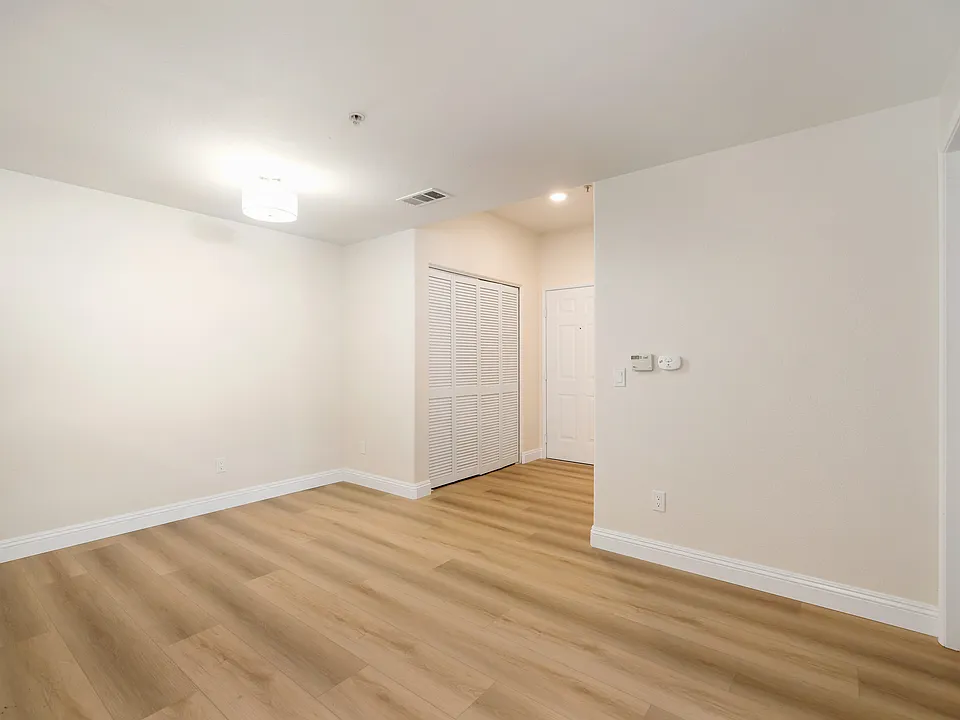 View of dining area, entry and laundry closet