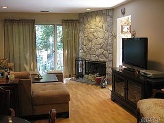Living room with stone fireplace