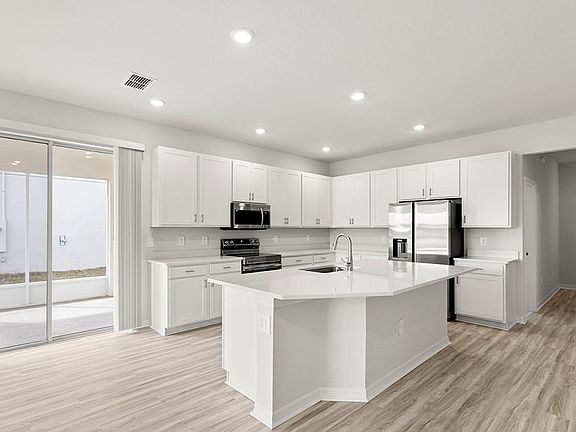Your bright, open kitchen includes a large island, pantry, and beautiful finishes - Danyella bungalo