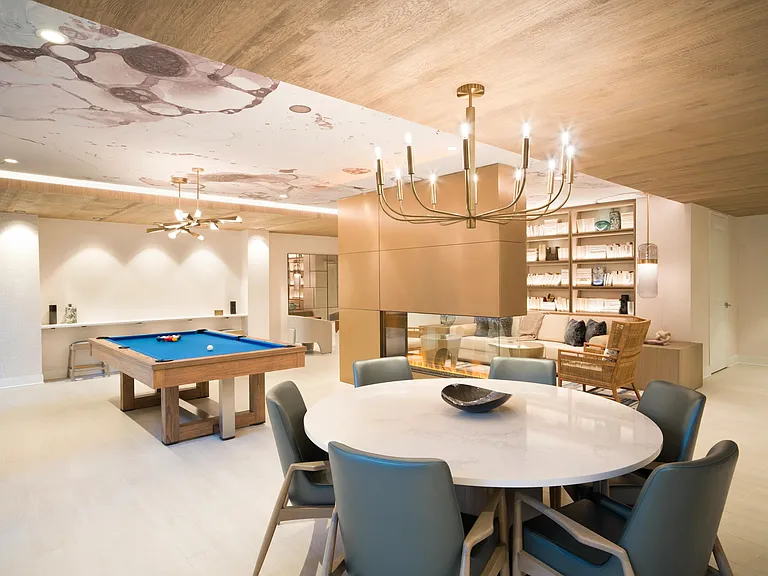 A thoughtfully designed clubroom with billiards, fireplace seating, and flexible gathering space at Modera Liberty Row.