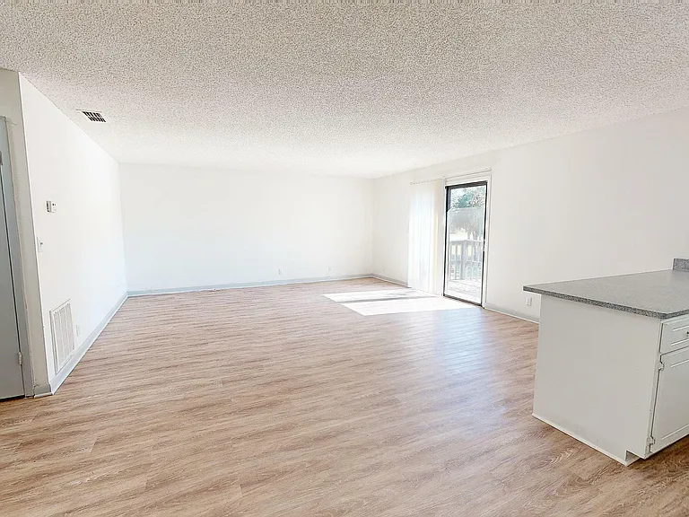 Experience the elegance and openness of modern living with this sunlit apartment space.