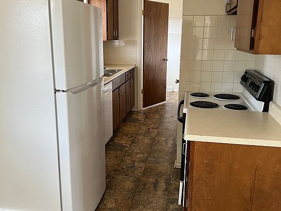Kitchen with half-bath/laundry room through door at back