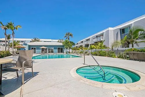 Pool, hot tub, and poolside lounge furniture are available for use within Montego Village.