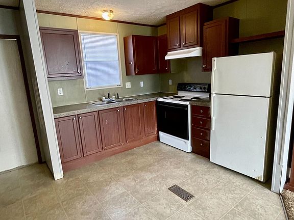 Eat in kitchen includes refrigerator, stove.
