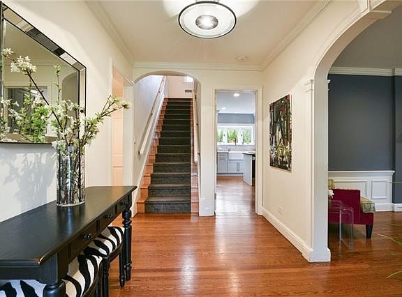 Warm and inviting center hall with stunning architectural moldings.
