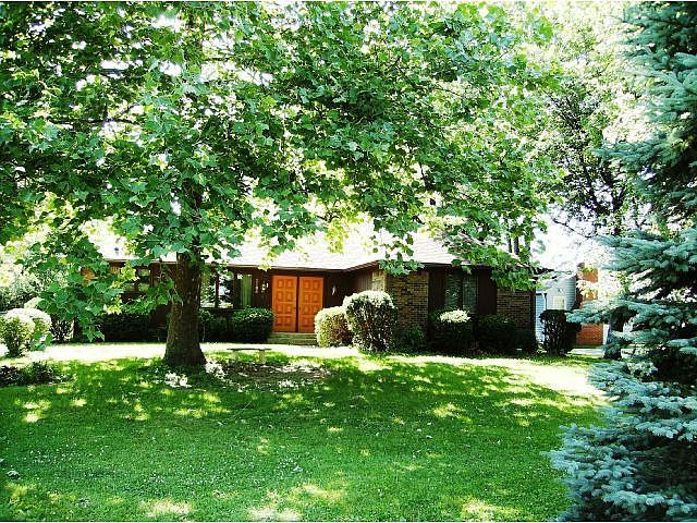 Large Sycamore tree and Pine trees offers privacy for this home.