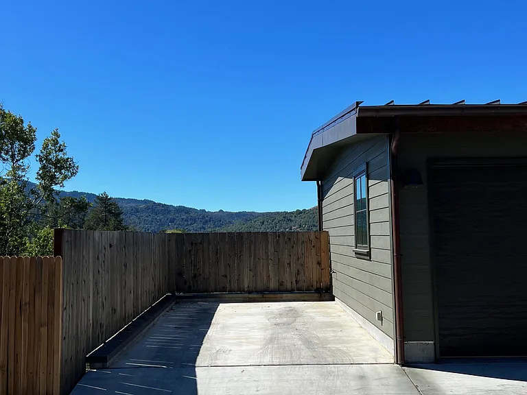 Additional parking space to the left of the garage.