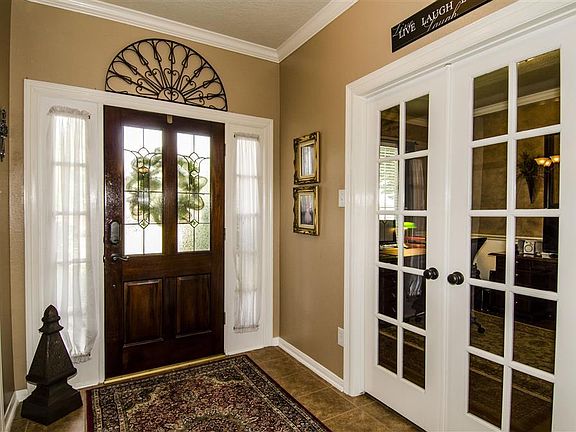 Tile formal entry with leaded glass front door & crown moulding. Formal dining on the right and study of the left.