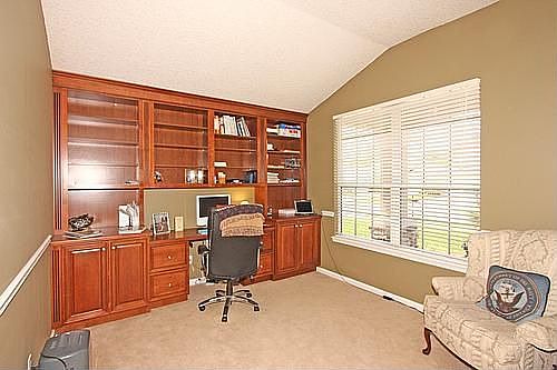 Built-in Desk with bookshelves, cabinets and roll outs.Chair rail in Office