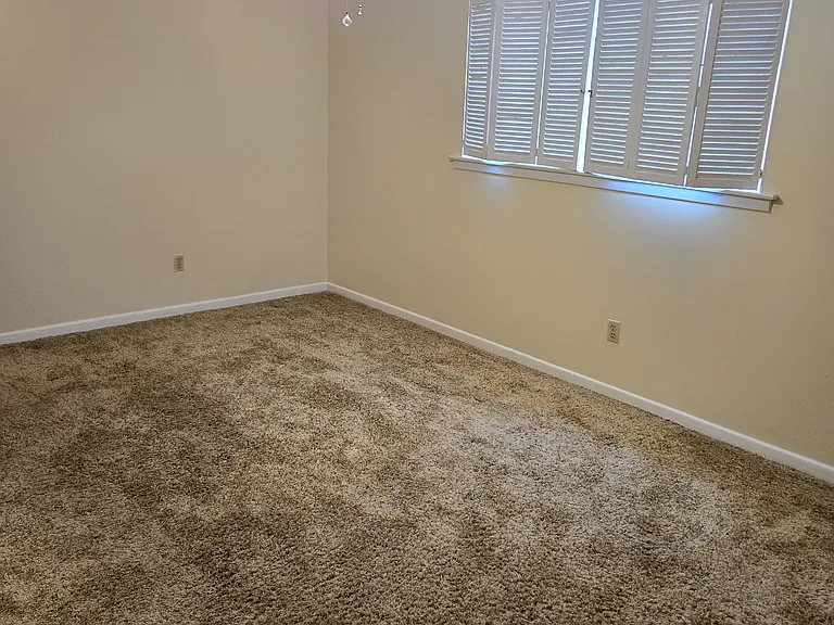 Second floor bedroom (left side) with ceiling fan.