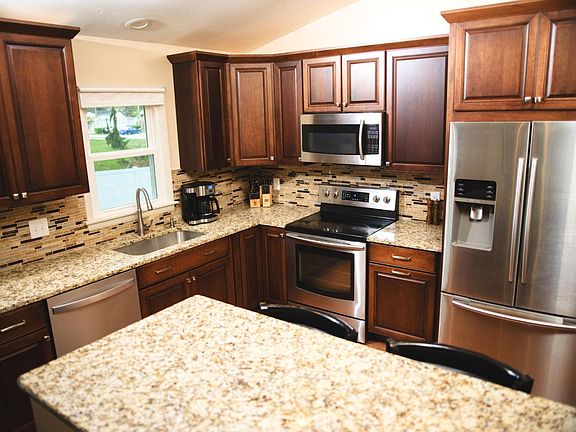 Dining room to kitchen view, bar height peninsula separates dining room and kitchen