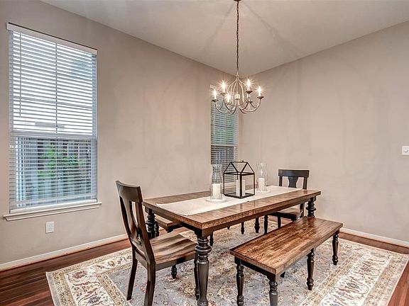 Formal dining with gleaming floors and large windows allowing lots of natural light.