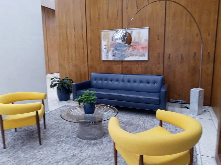 Guest area in the front lobby with classic mid-century modern furniture and Corbusier lamp.