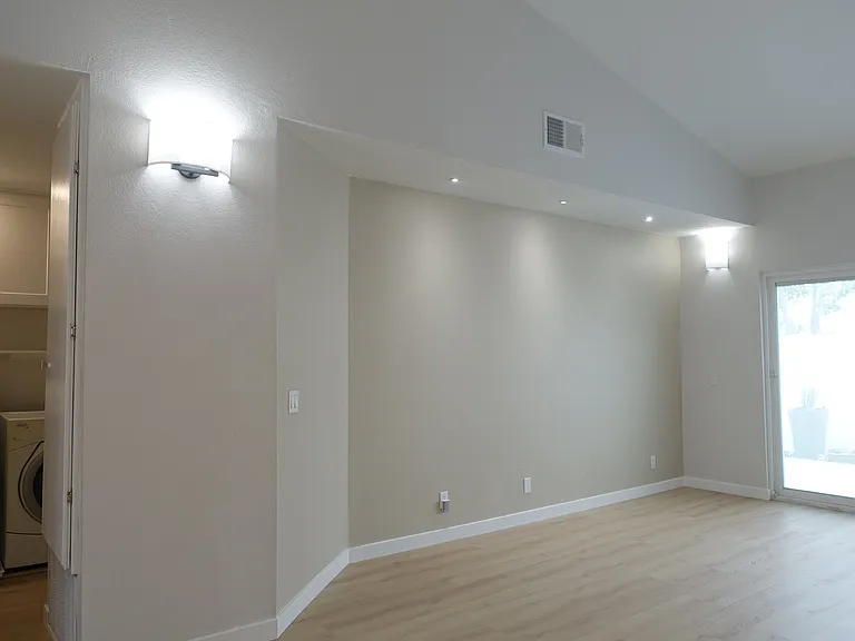Living Room: Spacious area with media nook and recessed lights.