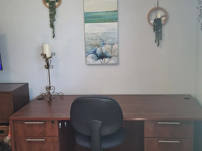 In room work area with large desk .