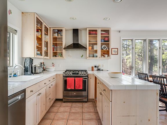 Full, well-stocked kitchen with5-burner gas stove, stainless steel appliances, including dishwasher.