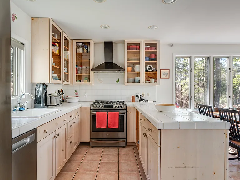 Full, well-stocked kitchen with5-burner gas stove, stainless steel appliances, including dishwasher.
