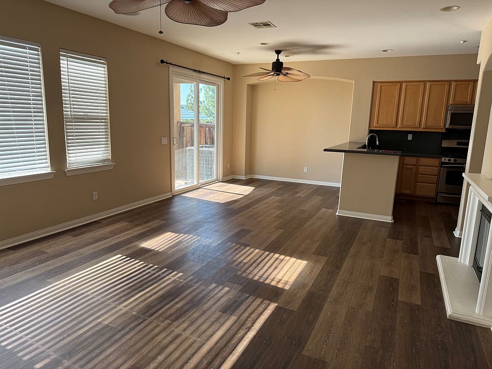 View from main entrance showing full living room and dining room area and patio entrance