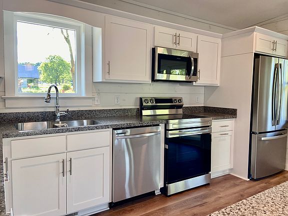 Electric stove and range, dishwasher, and French-door freezer/fridge.