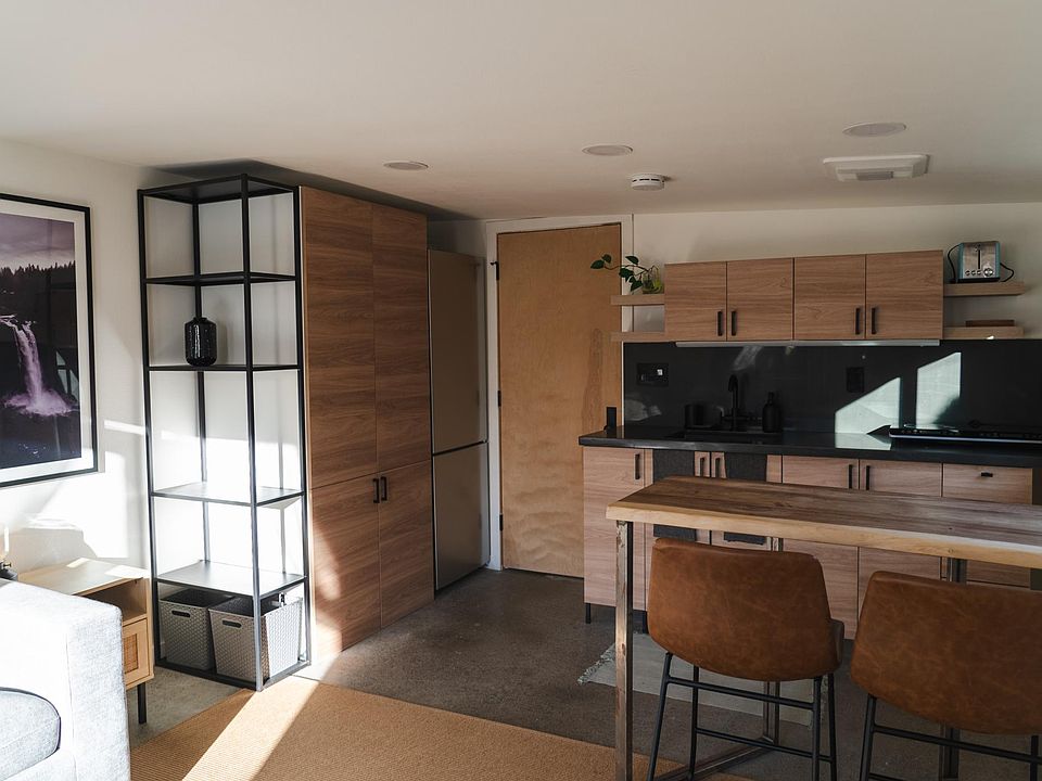 Polished concrete floors and warm natural tones create a sleek and comfortable living space.