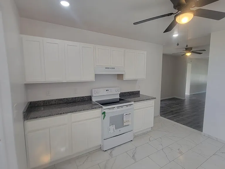 Tile kitchen has new appliances and granite counters.
