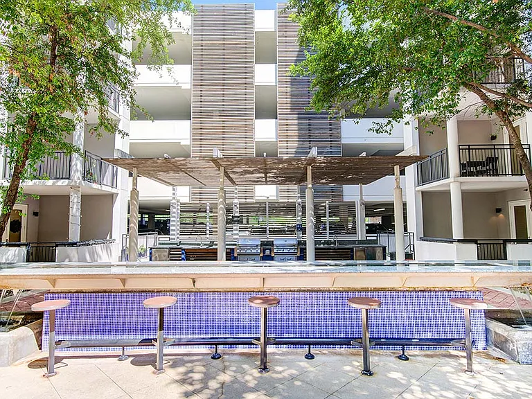 Griffis Uptown outdoor lounge with BBQ grills.