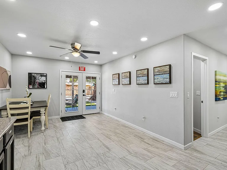 Open dining nook with tile flooring, recessed lighting, and French doors leading to the yard for easy indoor-outdoor meals.