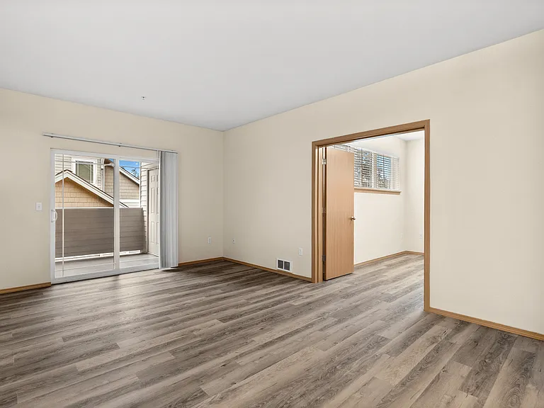 Spacious living area with modern flooring, private balcony access, and an open layout perfect for flexible living. Spacious living area with modern flooring, private balcony access, and an open layout perfect for flexible living.