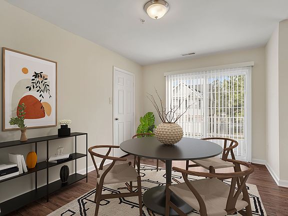 Dining area with vinyl plank flooring and walk-out private patio.