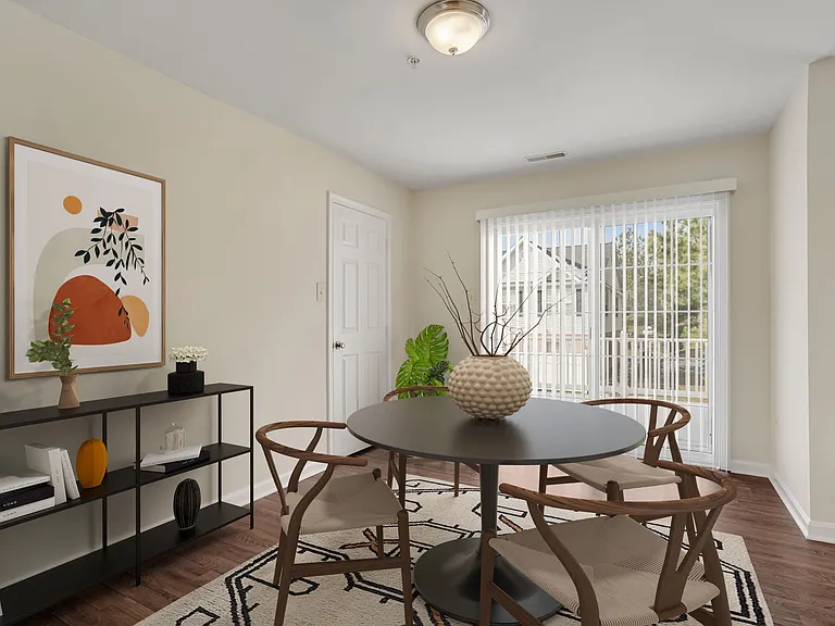 Dining area with vinyl plank flooring and walk-out private patio.