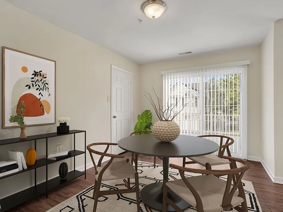 Dining area with vinyl plank flooring and walk-out private patio.
