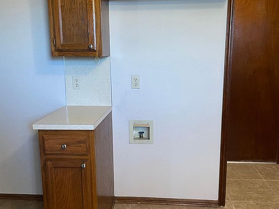 Refrigerator will go here. To the left as you walk in from the garage door which is shown to the right in the picture.