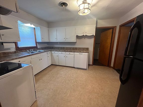 Kitchen with bathroom off of it